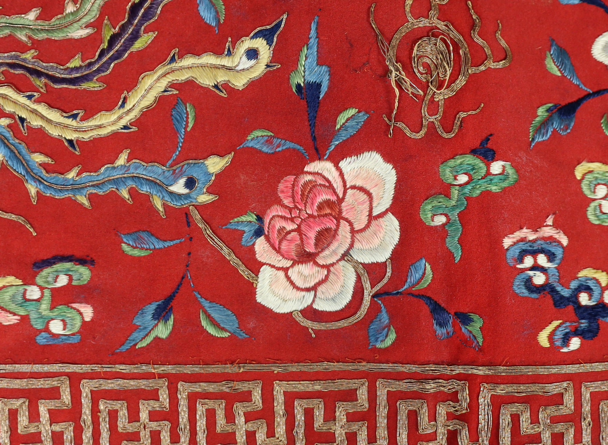 A Chinese embroidered silk ‘dragon, phoenix and lion’ panel or table frontal, late Qing dynasty, 117cm x 337cm